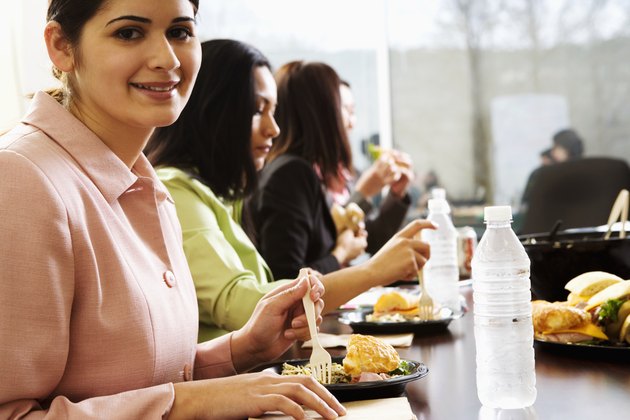 Female office workers sitting, eating