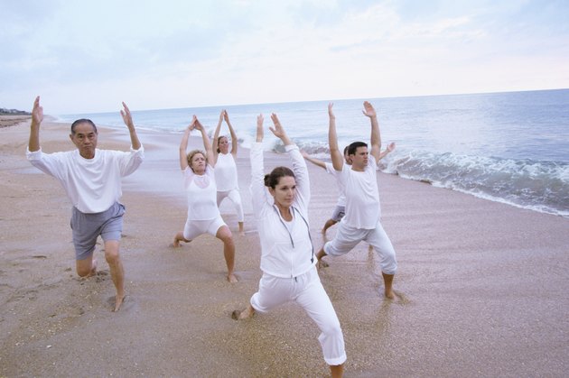 Group of people exercising on the beach