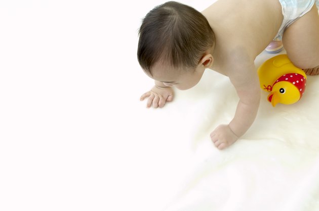 a toddling baby and a toy