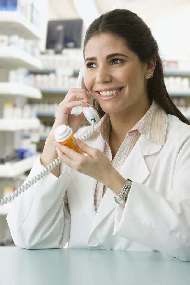 Hispanic female pharmacist talking on telephone