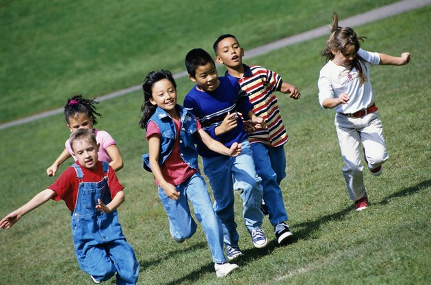 Group of children running on a lawn