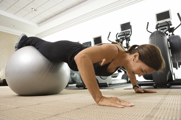Woman doing pushups on exercise ball