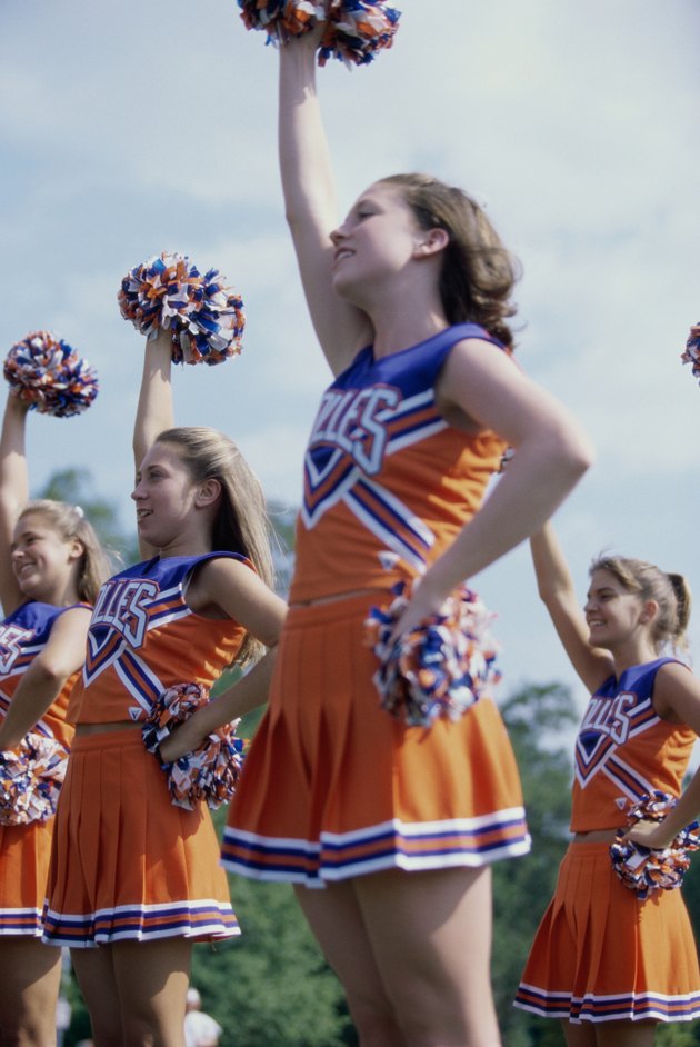 Side profile of cheerleaders with pom-poms