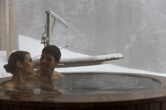 Couple in hot water tub, outside