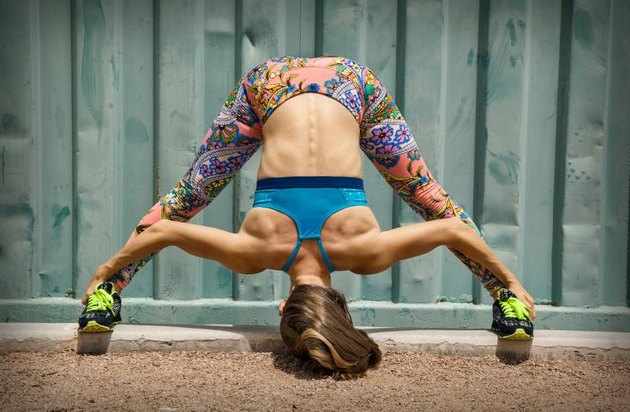 Fit woman doing exercise near the wall outdoor