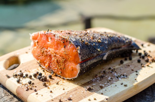 Prepared peace of fresh salmon fish with salt and pepper