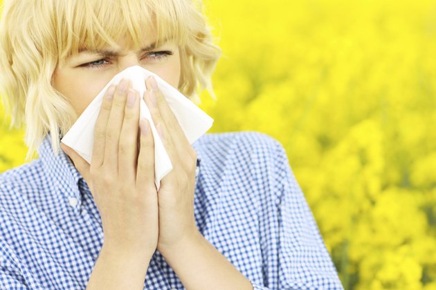 Woman with allergy over flowers