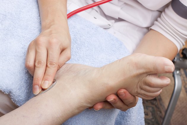 Female doctor examining a patient's foot