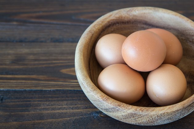 Eggs in wood bowl background