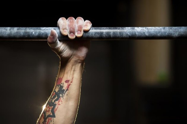 Closeup of male hand in horizontal bar. Pull ups exercise