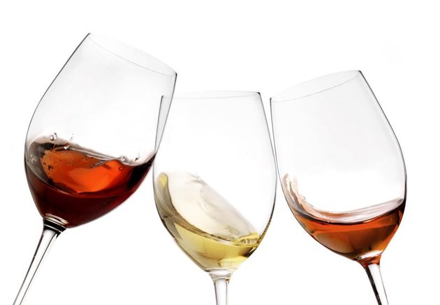 Toasting gesture red and white wine with splash, cheers close-up isolated