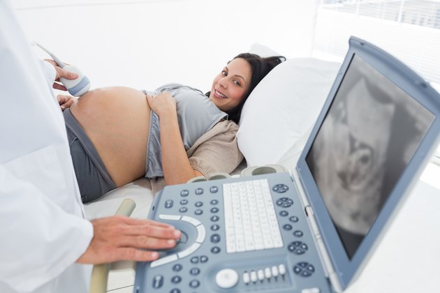 Doctor operating ultrasound machine
