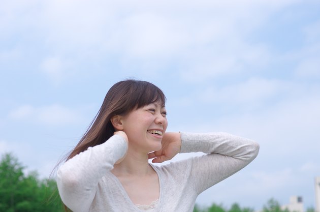 Asian woman combing her hair