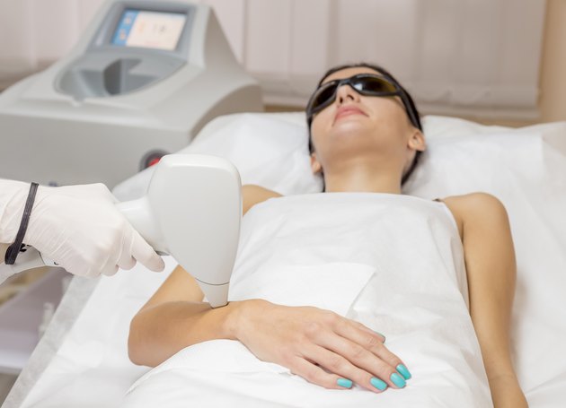 Laser hair removal on ladies hand in beauty salon