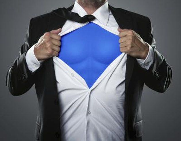 Young businessman acting like a super hero and tearing his shirt off with copy space