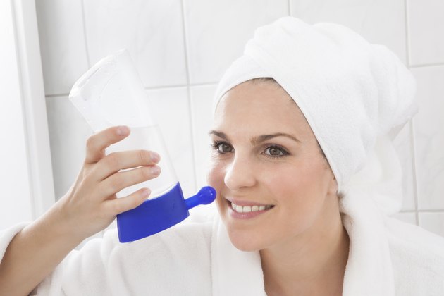 Young Woman Cleaning Nose