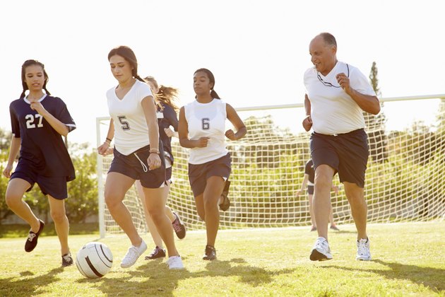 Members Of Female High School Soccer Playing Match