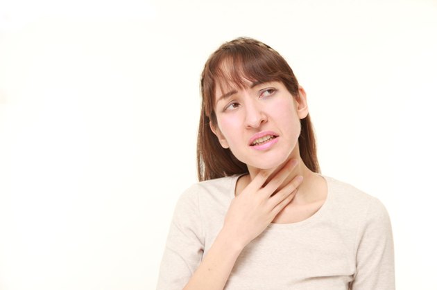 young woman having throat pain