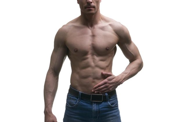Muscular middle-aged man posing on white background, isolated studio shot, perfect male body