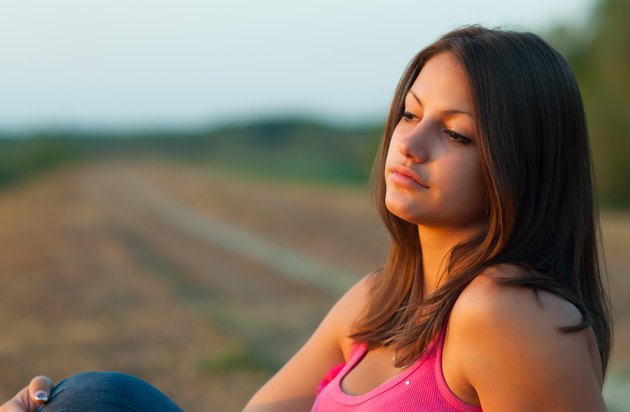 Beautiful girl sitting in the nature