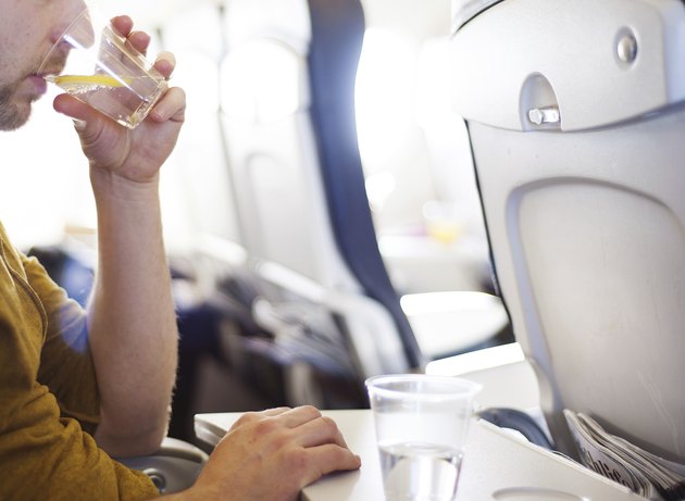 Man in the aircraft is drinking water
