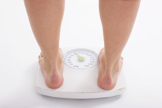 Woman standing on weight scale