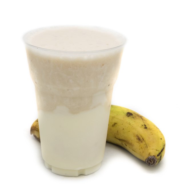 Banana smoothie on white background