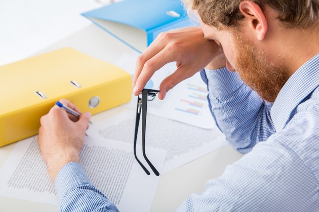 Tired worker rests her head on the desk