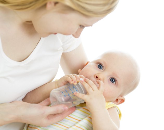 mother feeding his baby infant from bottle