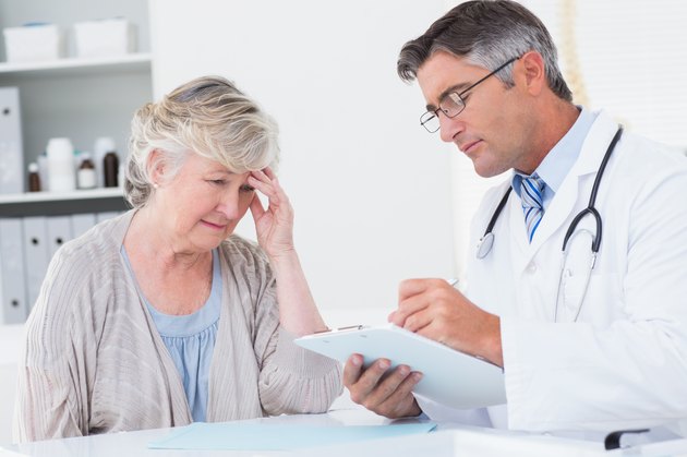 Doctor explaining prescription to senior patient