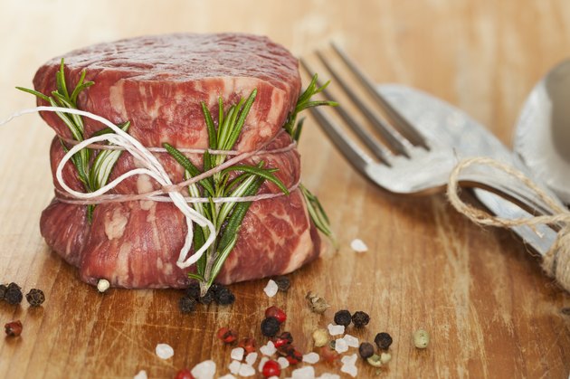 fresh raw beef fillet mignon on old wooden background