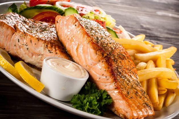Roasted salmon, French fries and vegetables