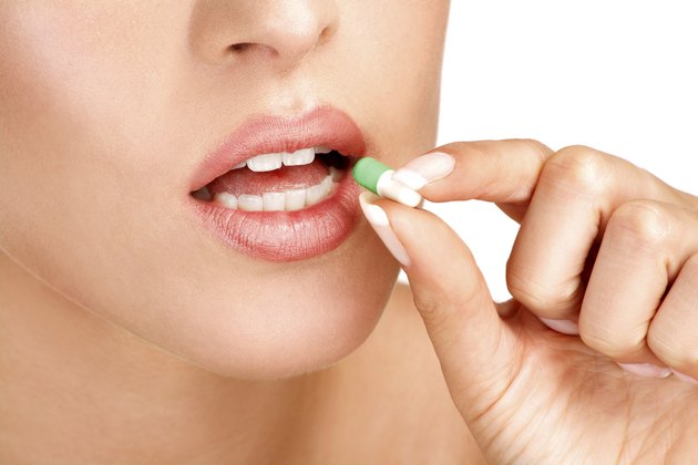 close up of a beautiful girl having pills