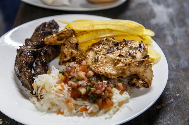 traditional nicaraguan cuisine, roast meat, salad and fried banana.