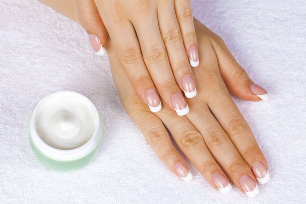 Woman's hands near jar of cream