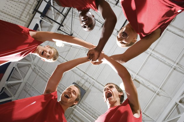 Basketball team in huddle yelling