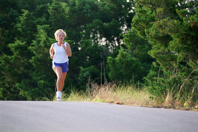 Woman jogging on side of road