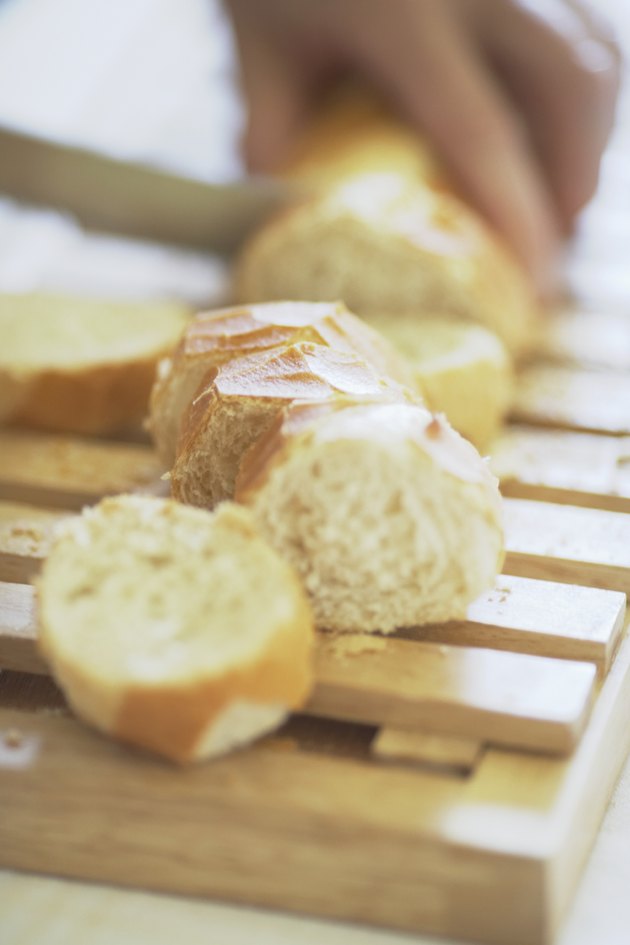 High angle view of a person cutting bread on a cutting board