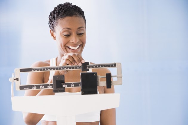 African American woman weighing self