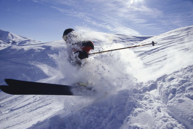 Skier landing in deep snow in mountains