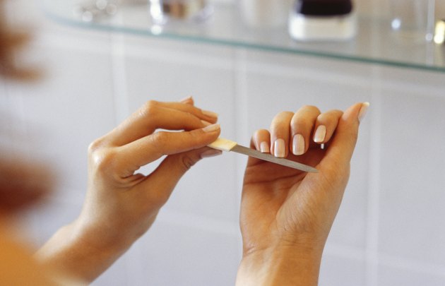 Woman filing nails with emery board, Close-up of hands, (Close-up)
