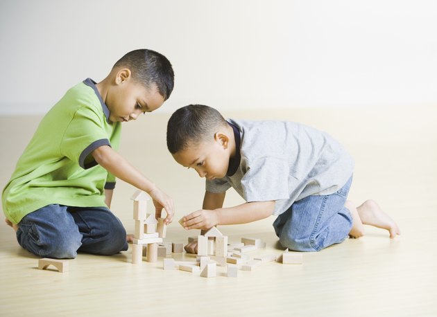 African brothers playing with wooden blocks