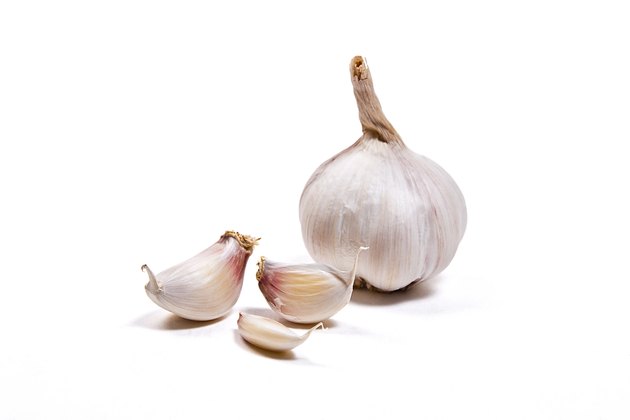 Two garlic bulbs isolated on white background