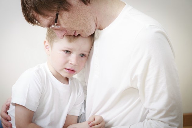 father comforting son in tears