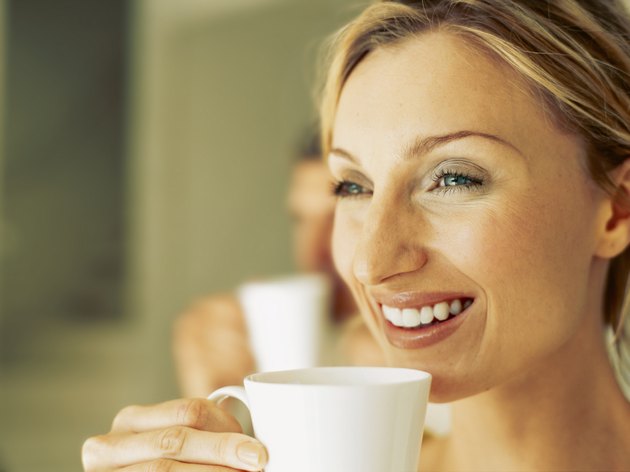 close-up of a mid adult woman drinking a cup of tea