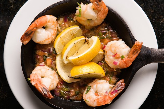 Shrimp and lemons over salsa in sautee pan