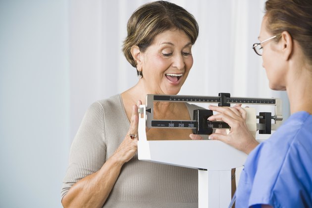 Senior Hispanic woman on medical scale
