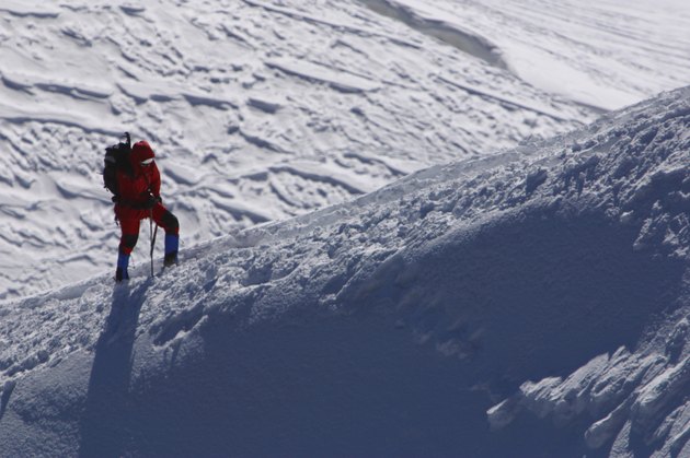 Person hiking in snow on mountain