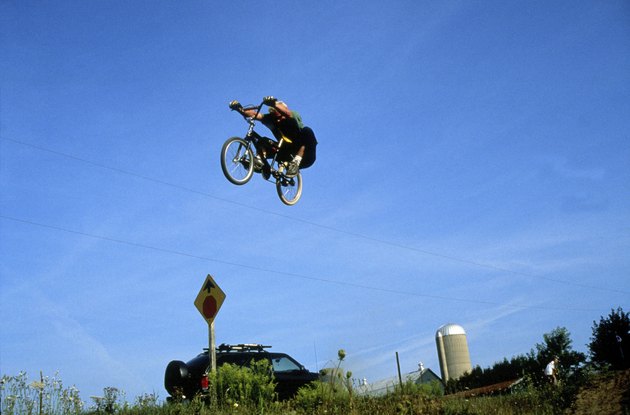 Low angle view of a man performing stunts on a bicycle