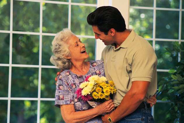 Son bringing flowers to his mother